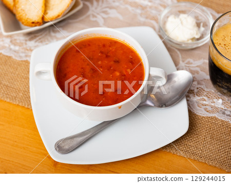 Borscht soup with beets served in bowl 129244015