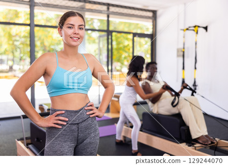 Portrait of positive girl in pilates gym 129244070