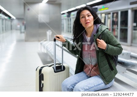 Woman traveler waiting train at subway station 129244477