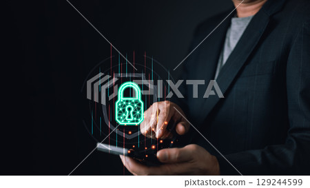 A person interacts with a smartphone, projecting a glowing digital lock symbolizing cyber protection. The futuristic interface highlights secure data, encryption, and online security measures. 129244599