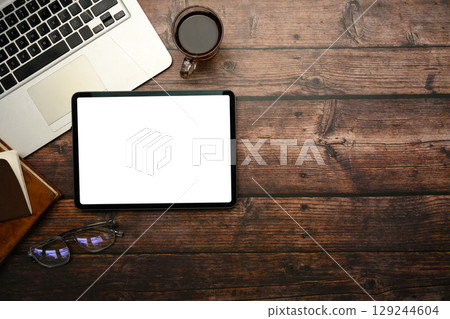 Top view of digital tablet with blank white screen on rustic wooden desk Top view of digital tablet with blank white screen on rustic wooden desk 129244604