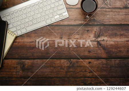 Top view of office essentials on vintage wood desk with copy space for text Top view of office essentials on vintage wood desk with copy space for text 129244607