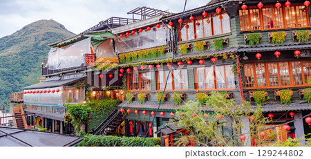 Jiufen Old Street is a narrow, winding alleyway with shops, teahouses, and restaurants that offers tourists a view of traditional Taiwanese life. 129244802