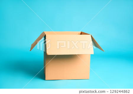 Open cardboard box on vibrant blue background 129244862
