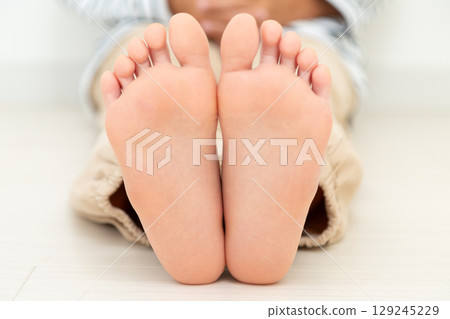 Soles of an elementary school boy's feet 129245229