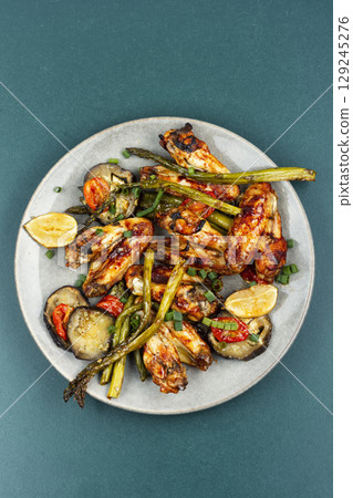 Hot and spicey chicken wings. 129245276
