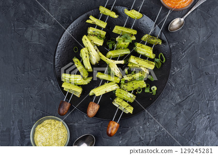 Vegetable celery skewers arrayed on a platter. 129245281