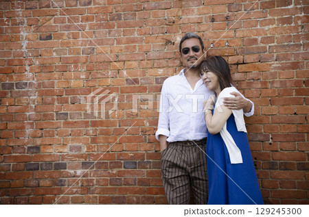一名女子站在一棟磚造建築前 129245300