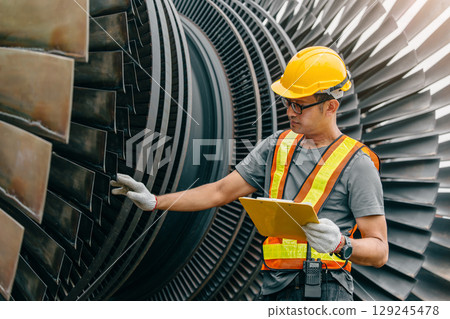 Professional Asian engineer male working service power plant turbine fan blade electrical generator Professional Asian engineer male working service power plant turbine fan blade electrical generator 129245478