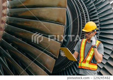 Professional Asian engineer male working service power plant turbine fan blade electrical generator Professional Asian engineer male working service power plant turbine fan blade electrical generator 129245482