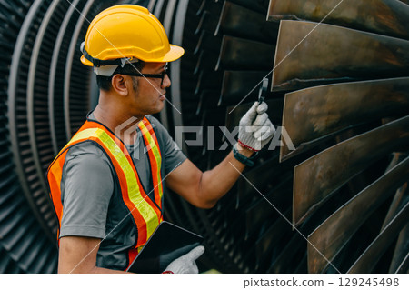 Professional Asian engineer male working service power plant turbine fan blade electrical generator 129245498