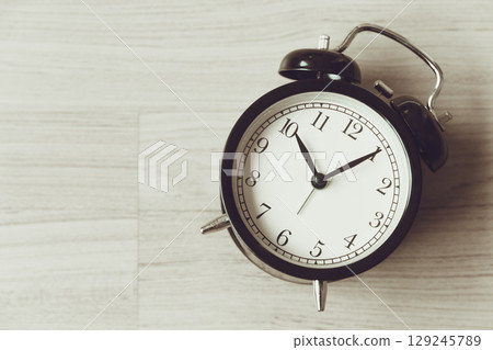 Bell clock old retro style at wooden background with copy space for text, history memory time 129245789