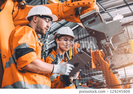 Engineer team service robot welding in automation factory. workers safety work robotic industry 129245809