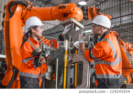 Technician engineer team fix service maintenance inspection robot arm installation in factory. Technician engineer team fix service maintenance inspection robot arm installation in factory. 129245834