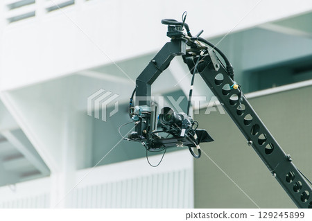 Camera Jib moving crane for high angle shot, Professional cinematography equipment in Video industry Camera Jib moving crane for high angle shot, Professional cinematography equipment in Video industry 129245899