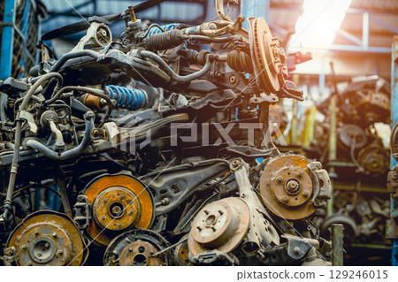 stock pile of used auto parts store for sale recycle, car old wheel hub spare part from scrapyard 129246015