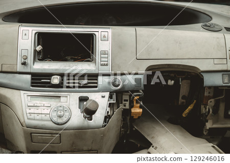 Car dashboard ruin, old, broken, rotten, damaged grunge dusty dirty abandoned in junkyard for spare 129246016