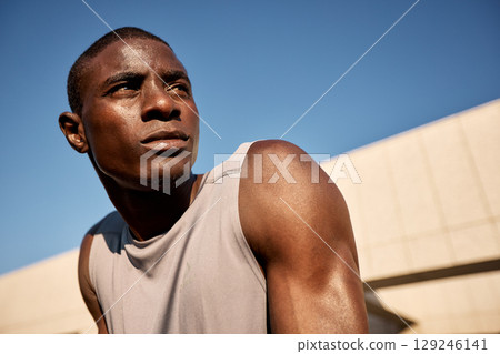 Portrait of a focused athlete outdoors under bright sunlight Portrait of a focused athlete outdoors under bright sunlight 129246141