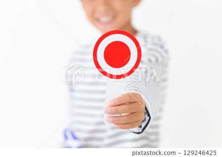 Elementary school boy smiling while holding a round plate Elementary school boy smiling while holding a round plate 129246425
