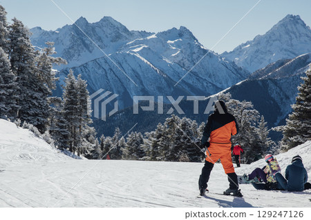 Snowboarders and skiers ski in the resort on the slopes Snowboarders and skiers ski in the resort on the slopes 129247126