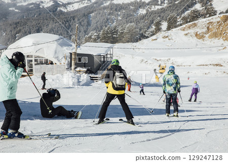 Snowboarders and skiers ski in the resort on the slopes Snowboarders and skiers ski in the resort on the slopes 129247128