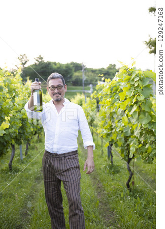 Man walking in vineyard 129247168