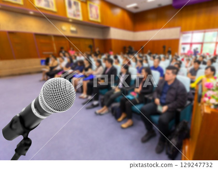 Microphone voice speaker with audiences or students in seminar classroom, lecture hall or conference meeting in educational business event for host, teacher, or coaching mentor. Microphone voice speaker with audiences or students in seminar classroom, lecture hall or conference meeting in educational business event for host, teacher, or coaching mentor. 129247732
