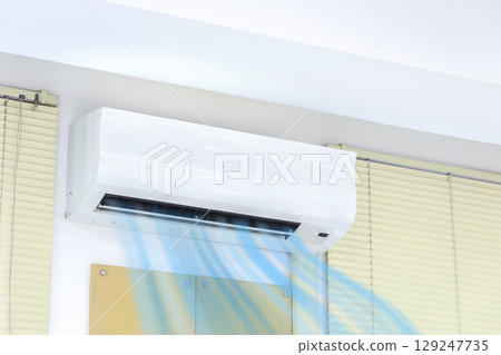 White Air Conditioner On Wall In Living Room. 129247735