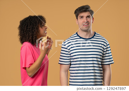 Grumpy mixed race woman yelling on man. Irritated boyfriend, diverse couple 129247897
