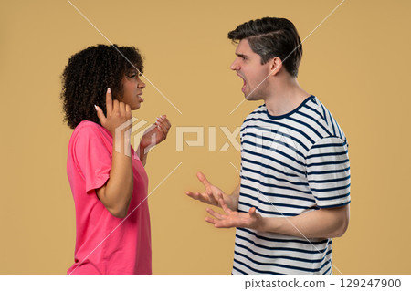 Interracial Couple Arguing Emotionally in Studio, Expressive Conflict Scene 129247900