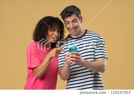 Interracial Couple With Mobile. Woman Man Watching Laughing With Smartphone 129247937