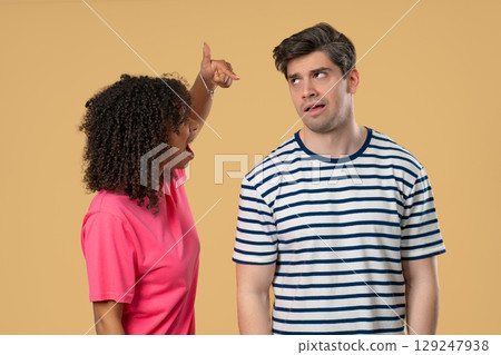 Grumpy mixed race woman yelling on man. Irritated boyfriend, diverse couple 129247938