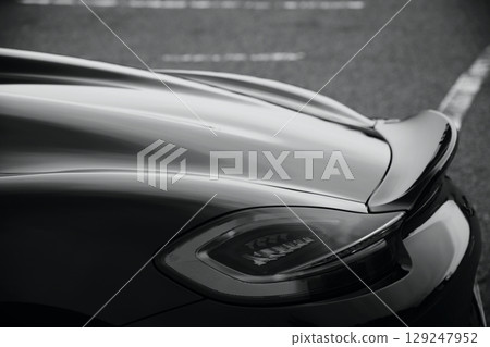 Glossy black sports car taillights and spoiler 129247952