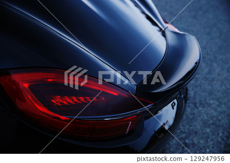 Glossy black sports car taillights and spoiler 129247956