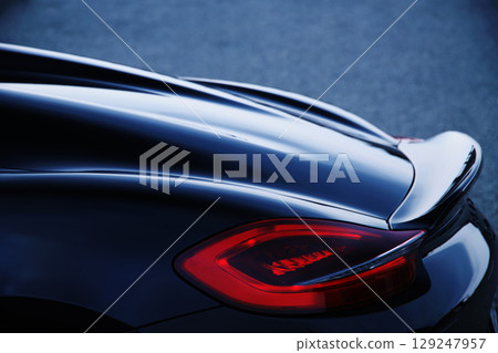 Glossy black sports car taillights and spoiler 129247957