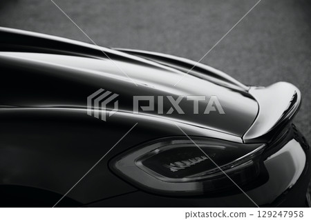 Glossy black sports car taillights and spoiler 129247958