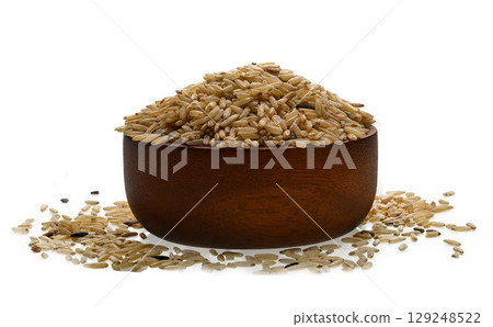Brown rice in wooden bowl isolated on white background. 129248522