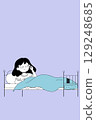 Girl in Bed Inserting Earplugs 129248685