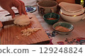 Preparation of fresh ingredients during culinary activity at local kitchen, showcasing traditional methods of food preparation, highlighting use of various spices and kitchenware 129248824