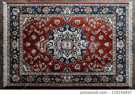 Handwoven Persian rug texture on a white background. Top view. Handwoven Persian rug texture on a white background. Top view. 129248897
