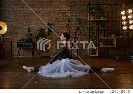 Ballerina in an artistic pose captured beautifully in her home studio environment Ballerina in an artistic pose captured beautifully in her home studio environment 129248990