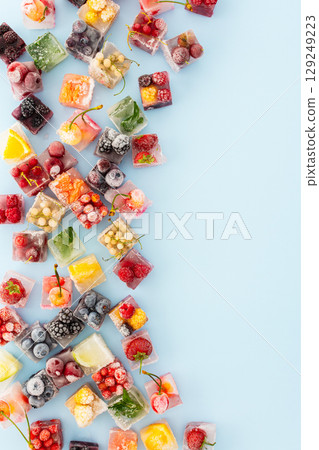 Blue background with ice berries cubes 129249223