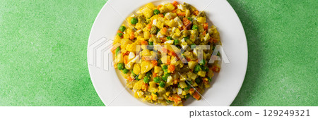 Colorful salad includes boiled egg, chicken breast, diced potatoes, carrots, and green peas mixed together and drizzled with olive oil, perfect for a healthy meal, banner 129249321