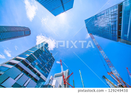 Tokyo cityscape, Japan, August 5th. Extremely hot... Huge heavy machinery such as piledrivers lined up... Towards a new chapter... = Shibuya 129249438