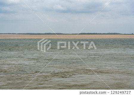 The meeting of the blue waters of the Tapajos River and muddy of the Amazon River in Santarem, Para State, Brazil. 129249727