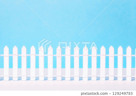 Wooden vintage white picket fence on blue background. Low rustic closed boundary design element, front view Wooden vintage white picket fence on blue background. Low rustic closed boundary design element, front view 129249783
