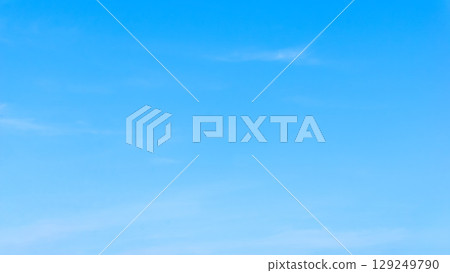Simple blue sky background photo: A clear, blue summer sky with faint clouds Simple blue sky background photo: A clear, blue summer sky with faint clouds 129249790