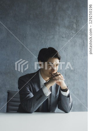 Businessman looking at display Businessman looking at display 129250196