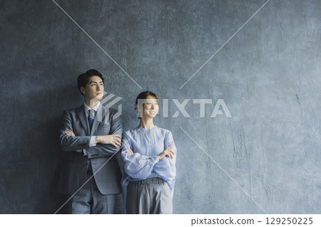 Business person with arms folded Business person with arms folded 129250225