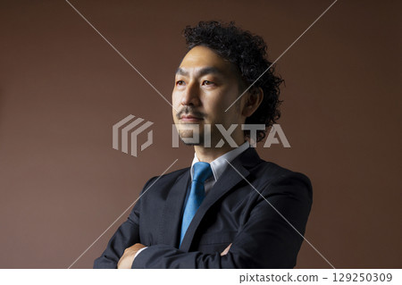 Bearded businessman in a suit Bearded businessman in a suit 129250309